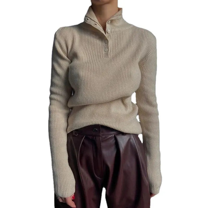 Women's silver grey slim fit pullover sweater with a half turtleneck and single-breasted placket on a hanger.