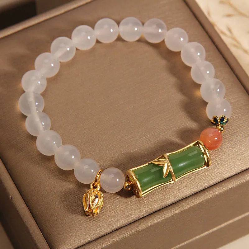 Women's natural style bracelet with jade beads, white agate centrepiece, and bamboo joint detailing.