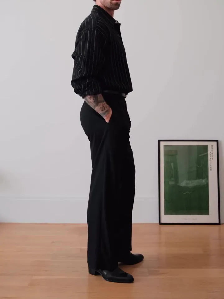 Black and white pinstriped long sleeve button-down shirt on a hanger.