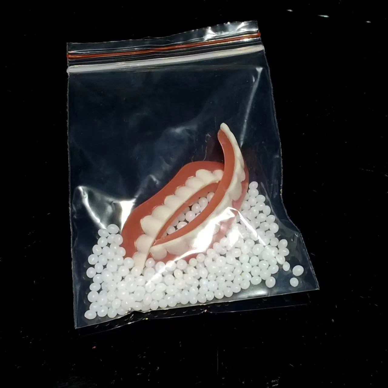 Silicone simulation dentures set showing upper and lower artificial teeth for dental training
