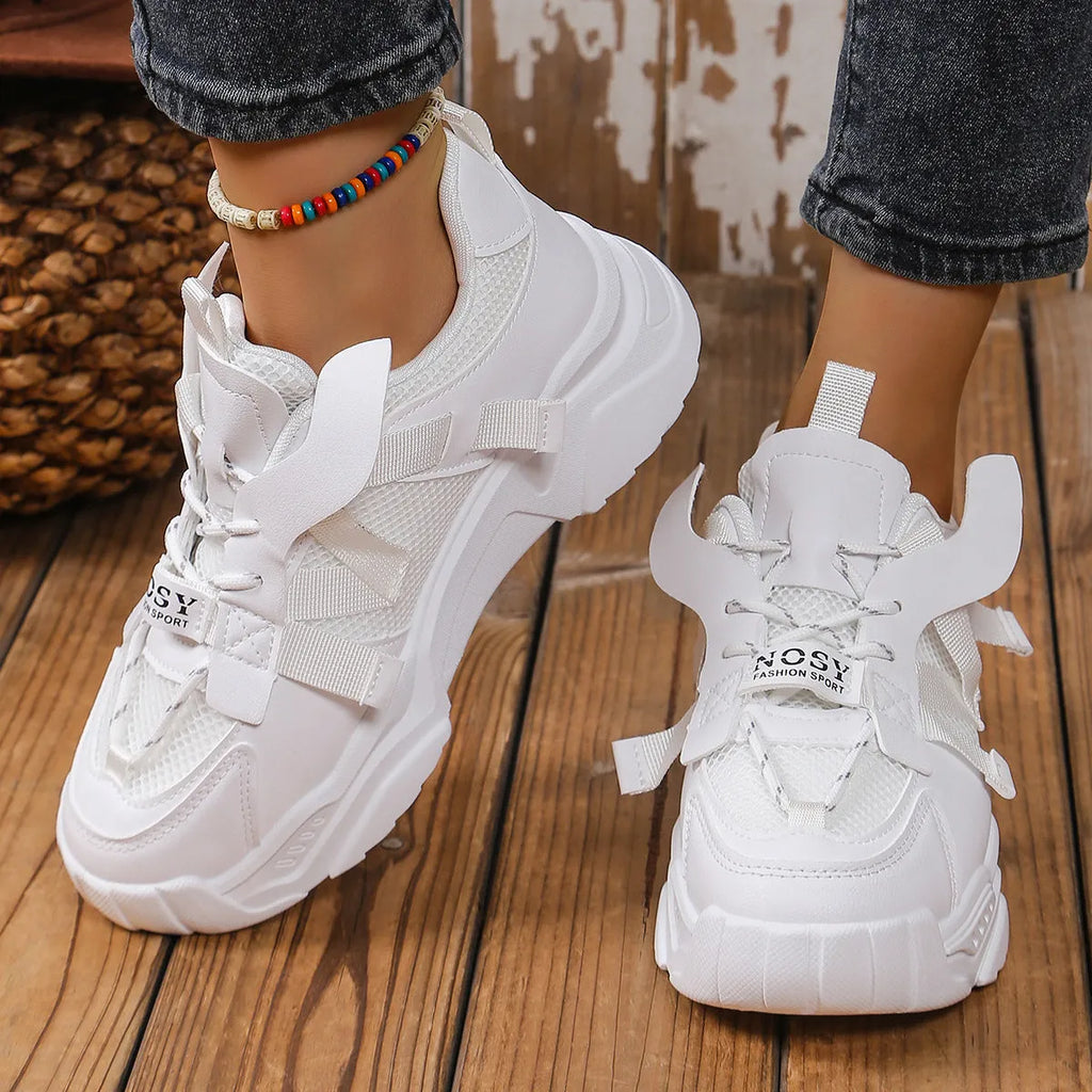 Women's purple platform mesh sports sneakers with animal pattern and lace-up front.