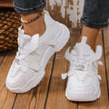 Women's purple platform mesh sports sneakers with animal pattern and lace-up front.