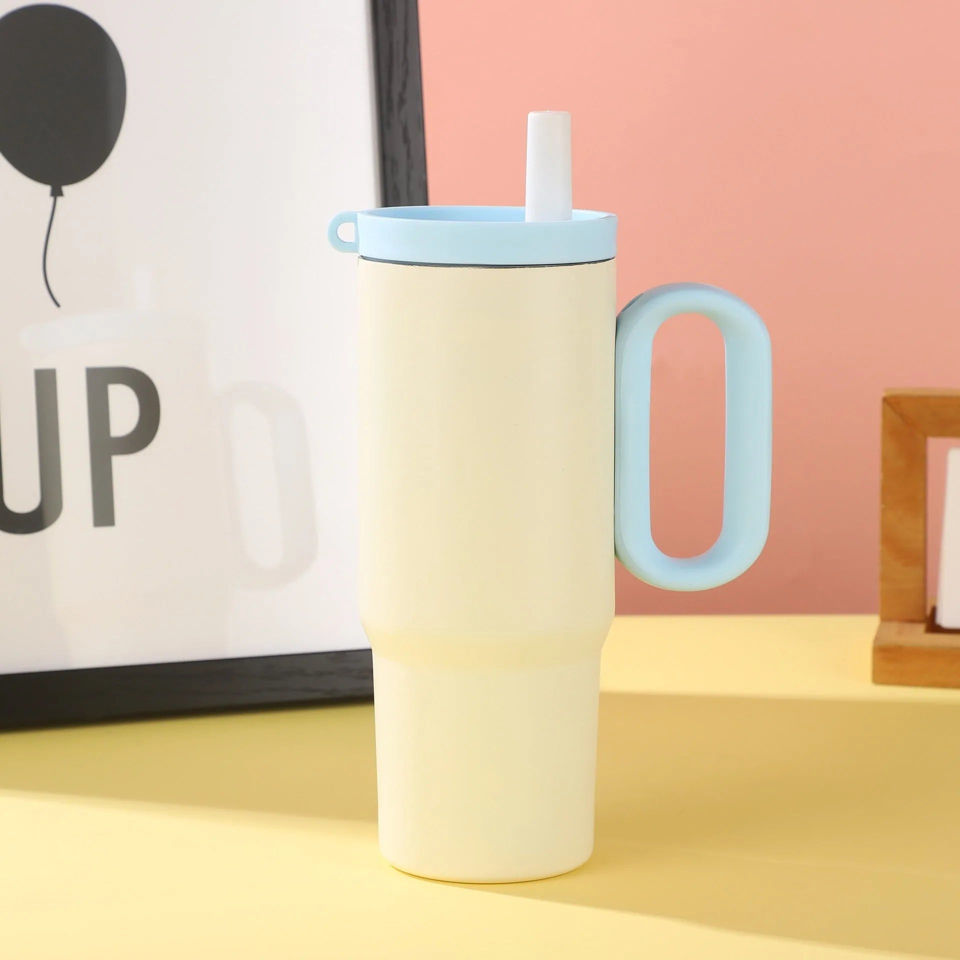 Large insulated straw drinking cup with a carrying handle in various colours.