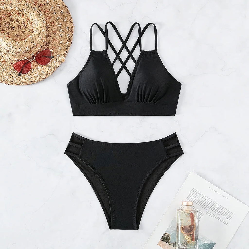 Women's black V-neck halter bikini with removable padded bra and split shorts.