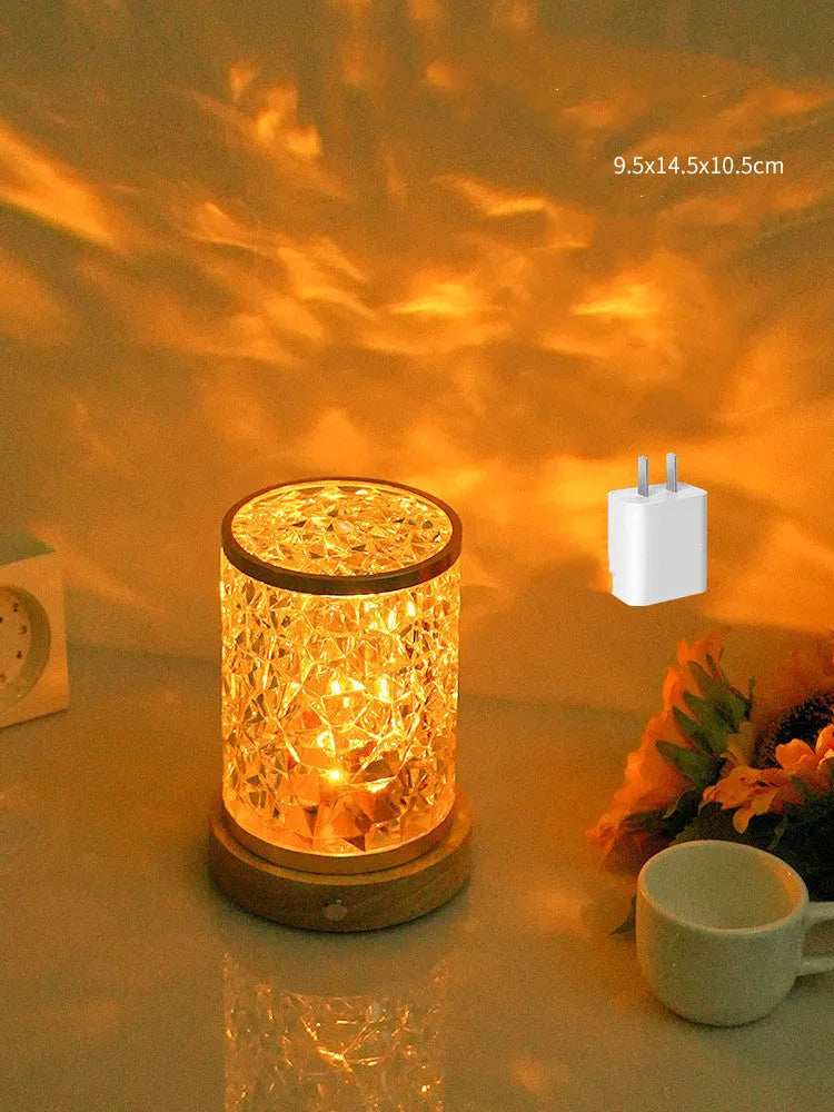 Modern rotating water ripple night light with acrylic body and solid wood base on a surface.