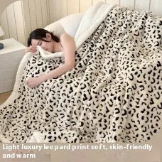 Double-layer leopard jacquard taffeta blanket in camel zebra pattern on a single bed.