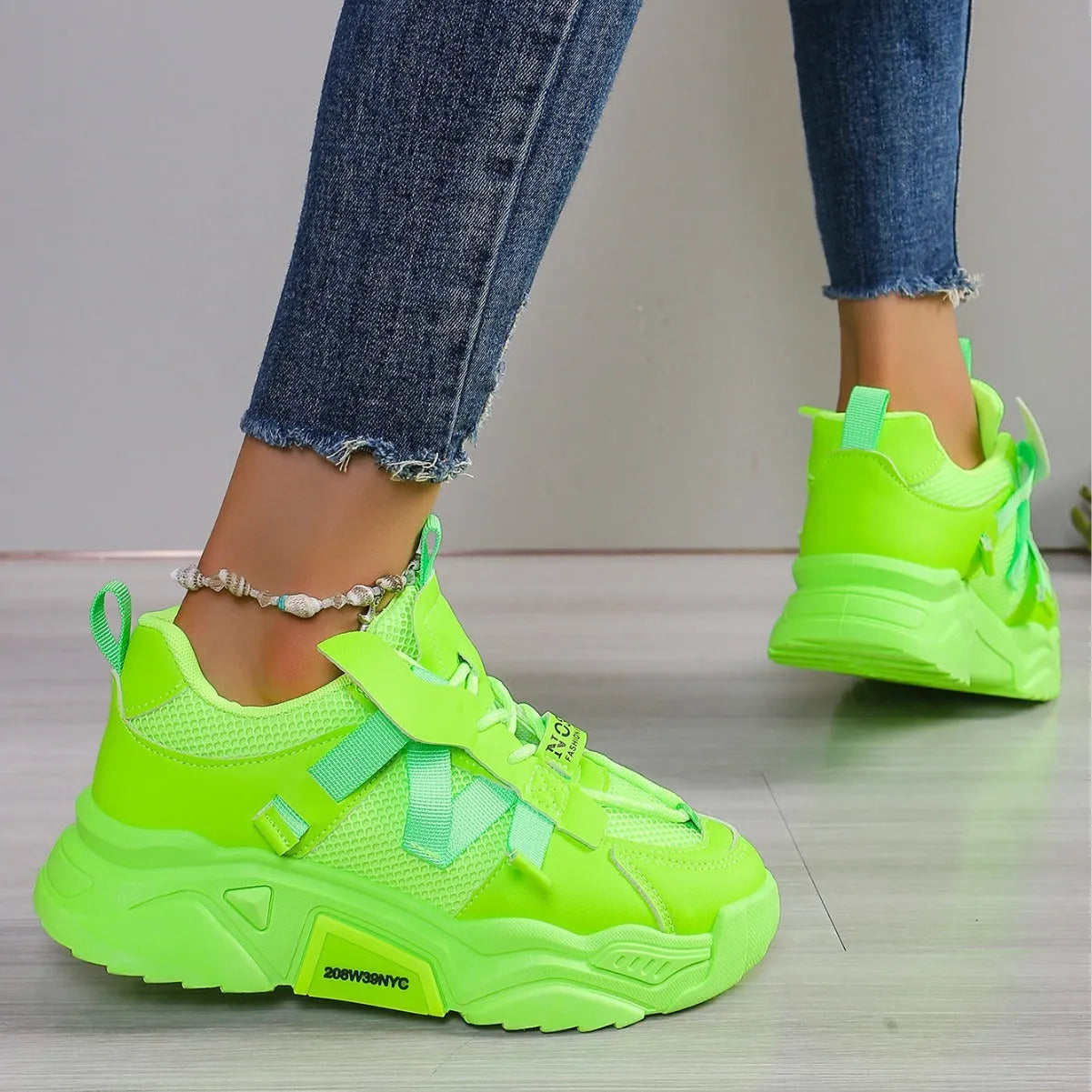 Women's purple platform mesh sports sneakers with animal pattern and lace-up front.