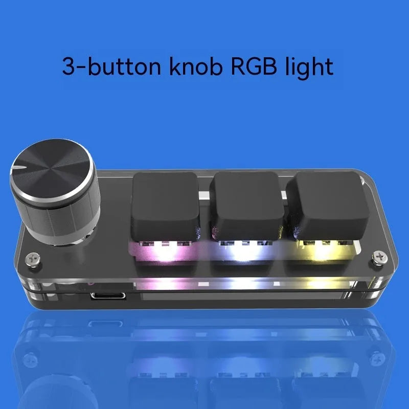 Compact black USB mini keyboard with RGB backlit keys labelled Copy and Paste on a desk.