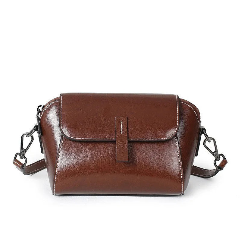 Brown shell-shaped women's messenger bag in soft oil wax leather with a single shoulder strap