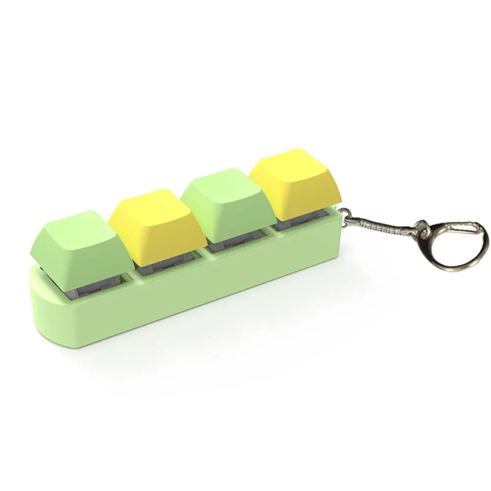 Four-key mechanical keyboard switch tester made of ABS plastic on a desk.
