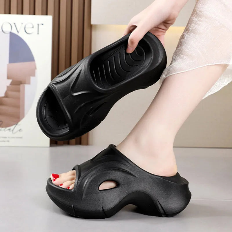 Women's white EVA slippers with thick sole and round toe on a beach background