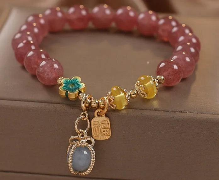 Red women's beaded bracelet with natural strawberry quartz stones and sparkling rhinestone accents.