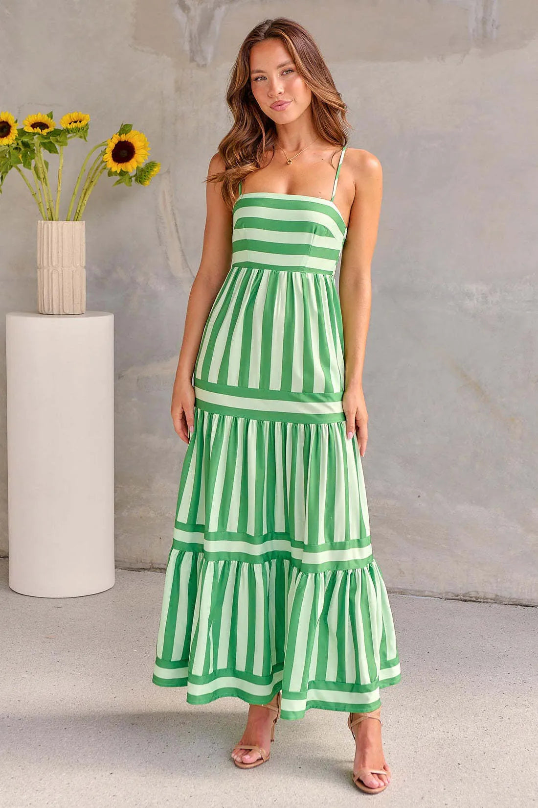 Women's long striped summer dress with suspenders, a square neckline, backless design, and side pockets.
