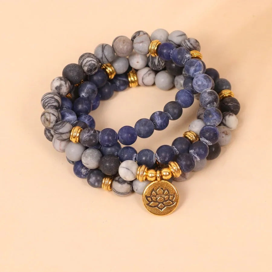 Layered multi-strand bracelet with blue patterned network stone beads and alloy toggle clasp