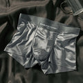 Men's light gray Ice Silk mid-waist underwear briefs laid flat.