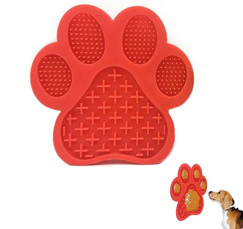 Blue silicone dog licking mat with bone-shape texture and suction cups on a tiled wall.