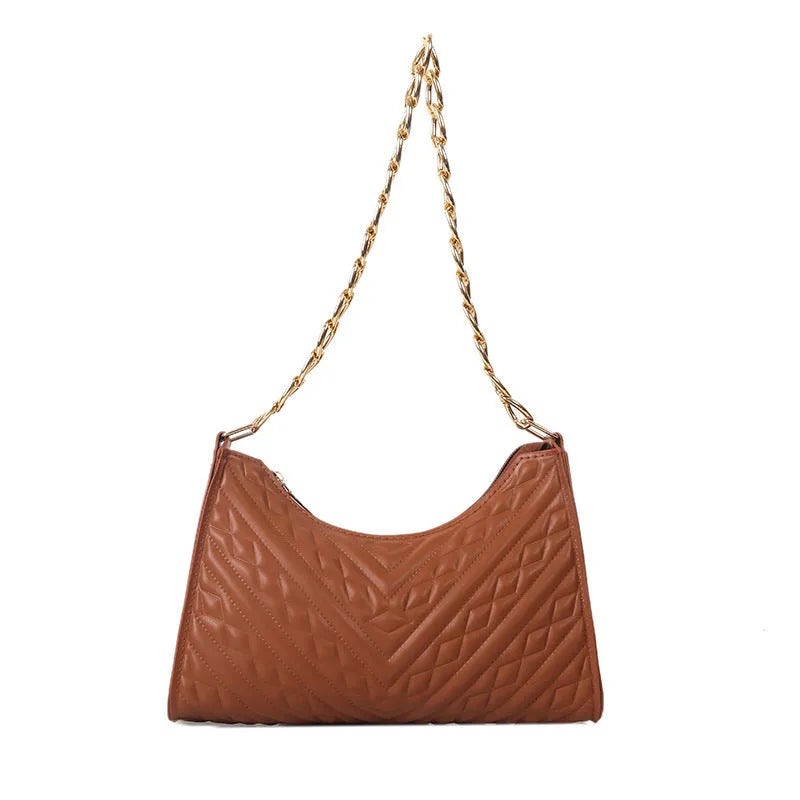 Vertical square brown PU shoulder bag with chain strap and soft handle on a table