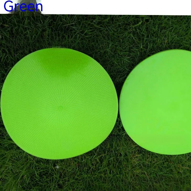 Yellow TPE football training target disc on grass, 23cm diameter flat landmark pad