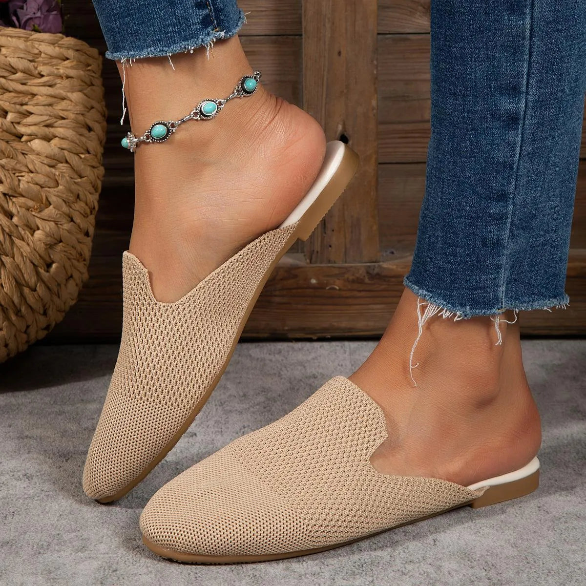 A pair of apricot-coloured mesh slip-on sandals with a cloth upper and flat rubber sole.