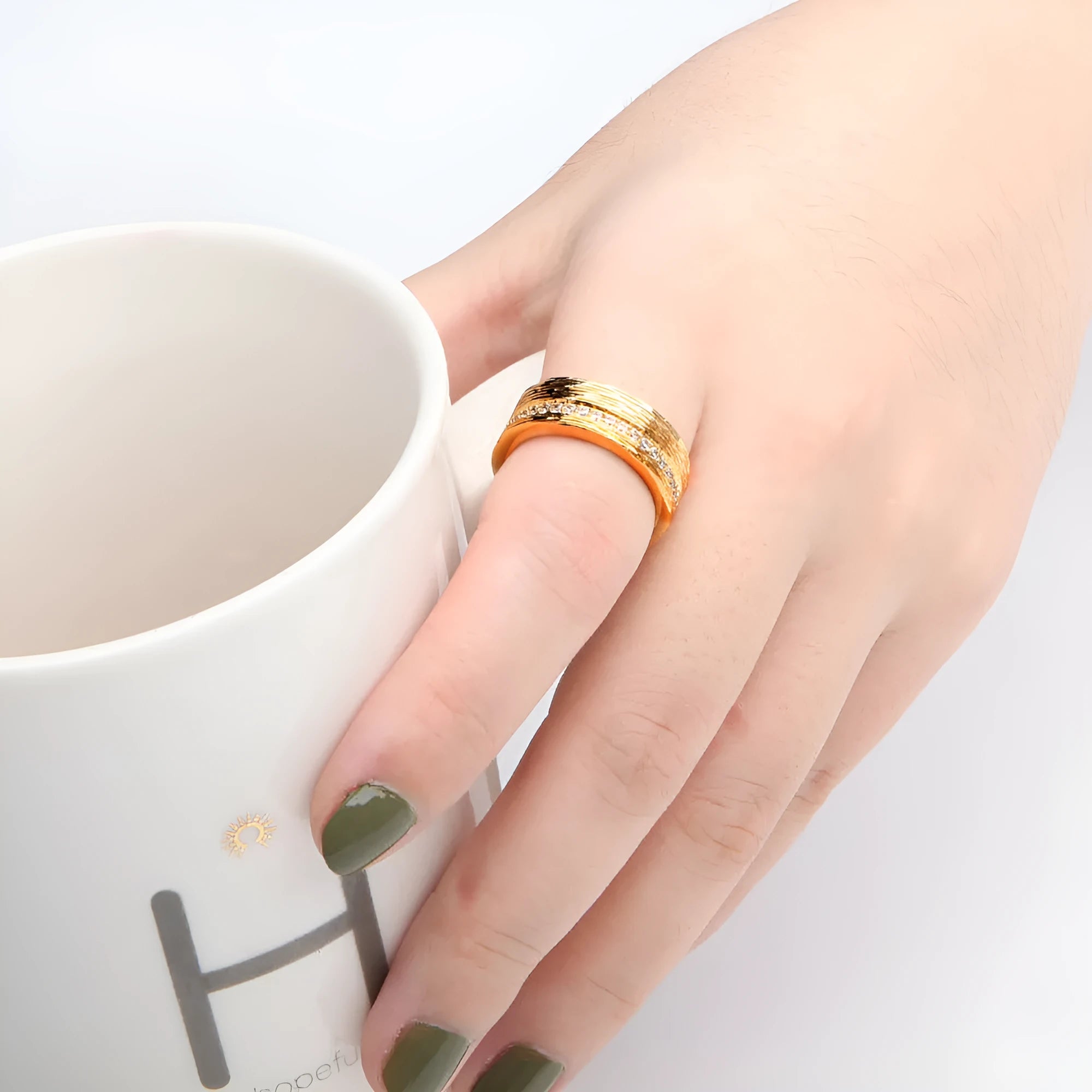Women's geometric zircon ring in gold electroplated copper showing structured design lines