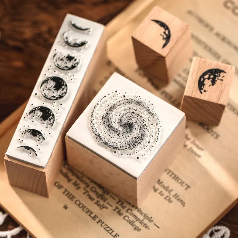 Wooden decorative seal stamp set with seven pieces showing botanical or celestial designs in mixed sizes