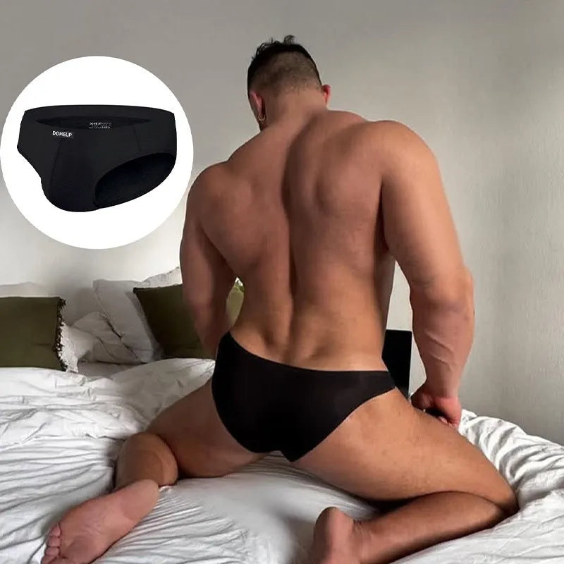Men's solid colour seamless low waist briefs in white, shown flat.