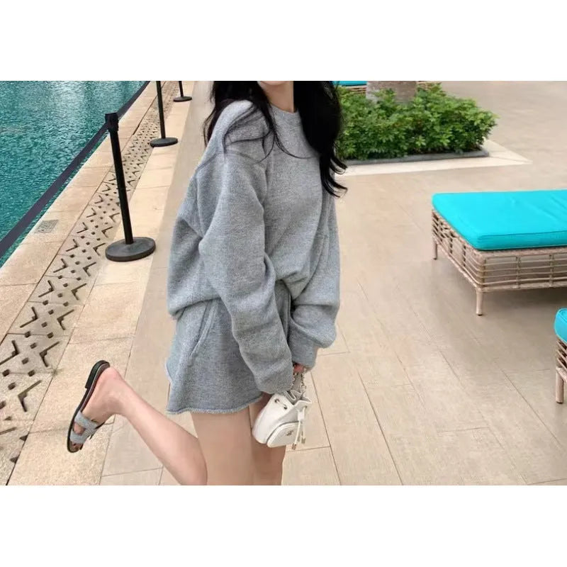 Women's knitted two-piece set showing long sleeve sweater with wide leg shorts in oatmeal colour