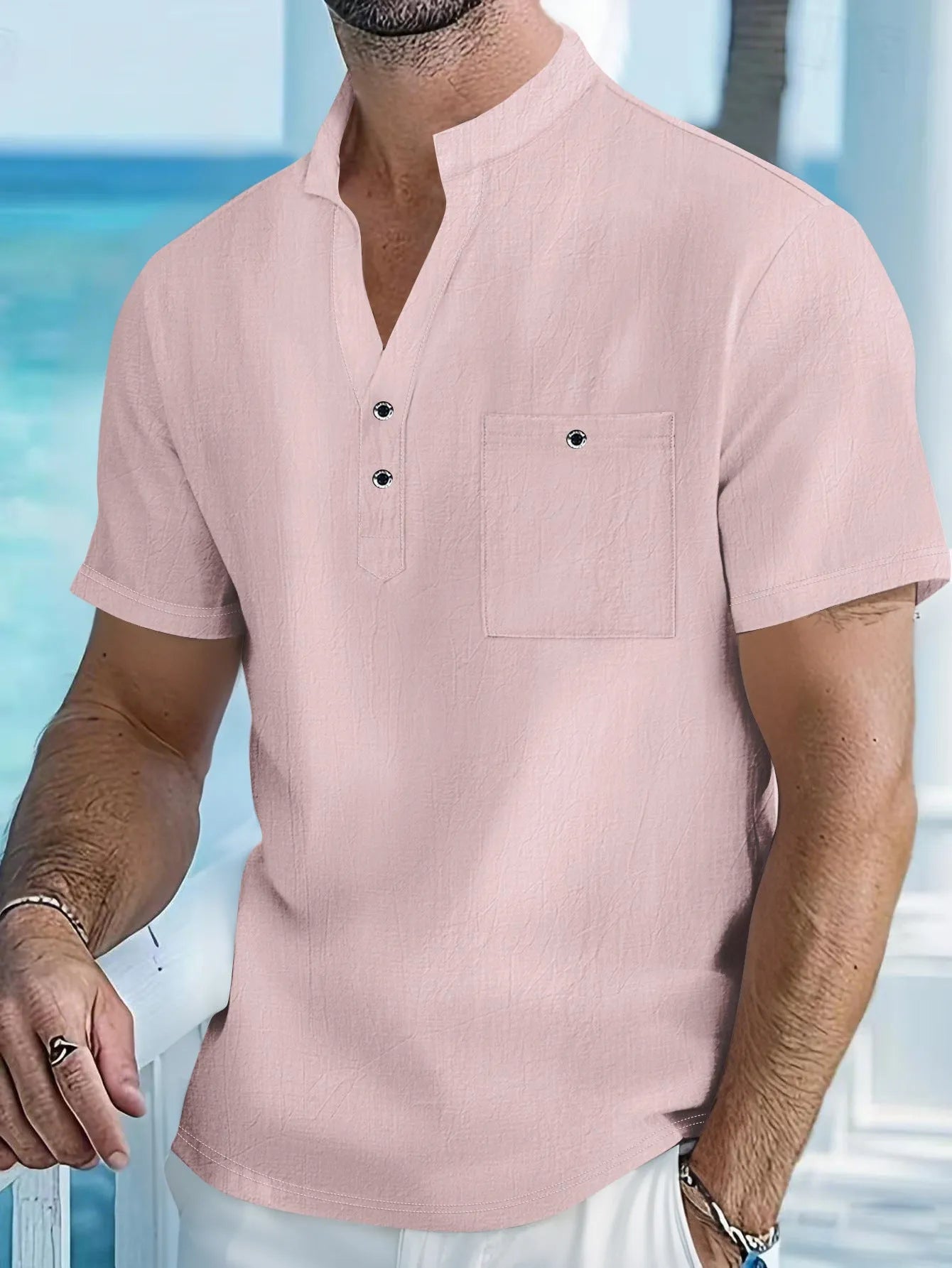 Man wearing a light blue linen-blend stand collar T-shirt with short sleeves and a loose fit.