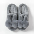Women's high-top rabbit fur slippers in creamy white colour with floral detail.