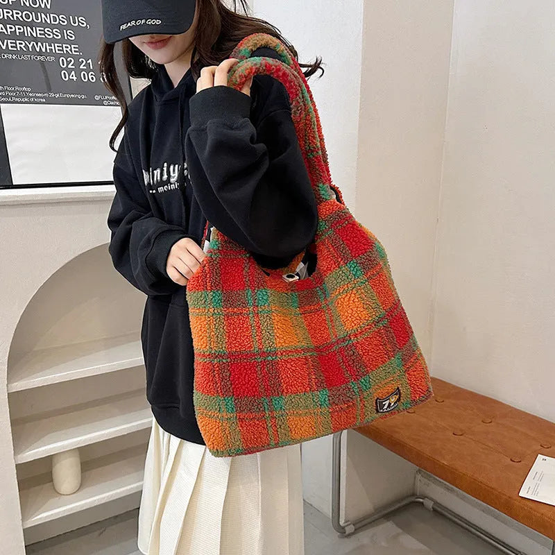 Women's plaid crossbody shoulder bag in soft plush fabric showing horizontal square shape and large capacity