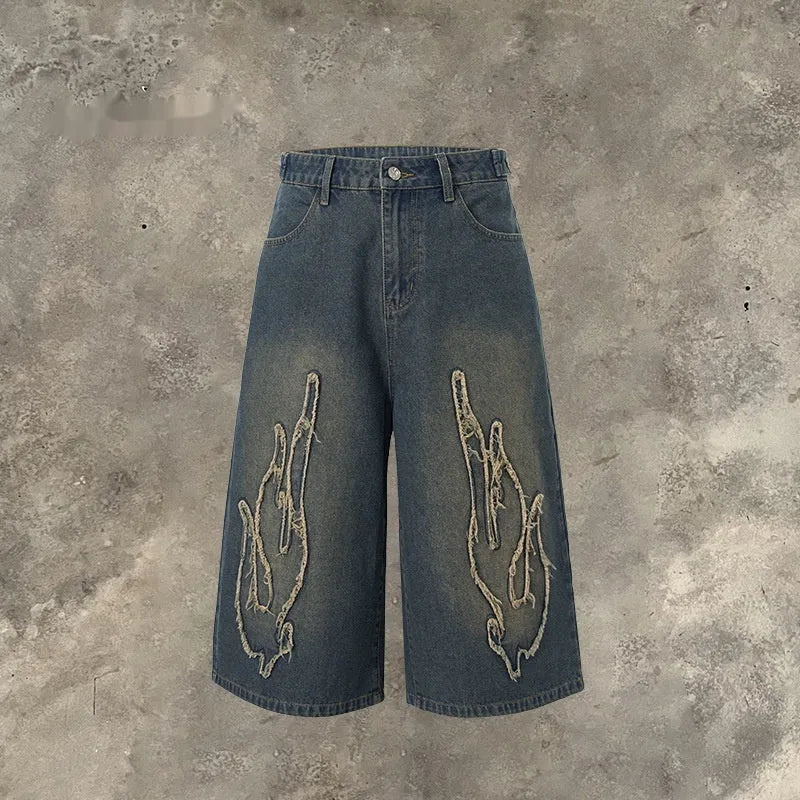 Men's black denim shorts with flame embroidery and patchwork design, straight leg cut