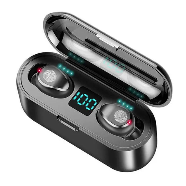 Wireless Bluetooth headset in black with earbuds and charging cable on a desk