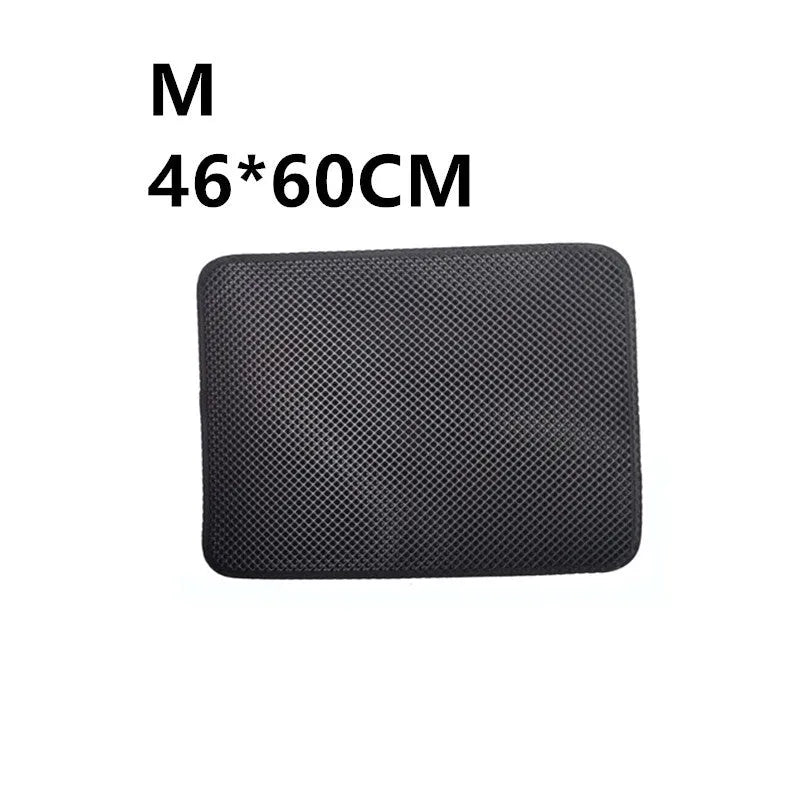Double layer EVA cat litter mat in black with textured surface, placed under a litter box to trap debris