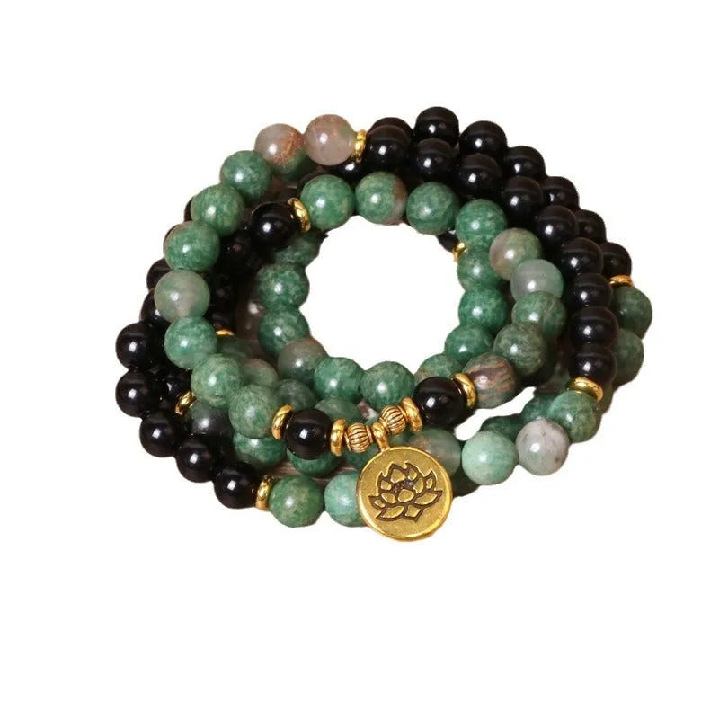 Green and black elastic beaded bracelet with alloy metal construction and natural style design