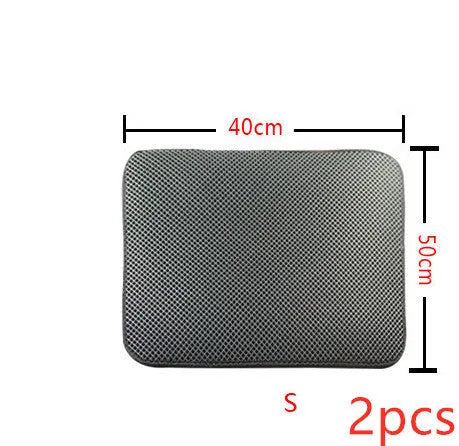 Double layer EVA cat litter mat in black with textured surface, placed under a litter box to trap debris