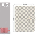 Loose-leaf notebook with red imitation leather cover, checkered pages, and ring binding in A5 size