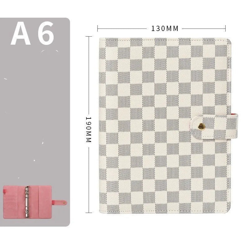 Loose-leaf notebook with red imitation leather cover, checkered pages, and ring binding in A5 size