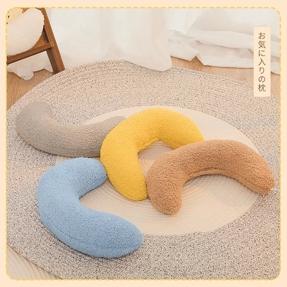 U-shaped blue cat pillow with adjustable collar for cervical support on a sofa