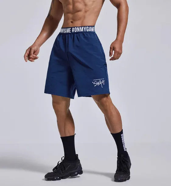 Men's grey workout shorts with loose cropped fit and letters detailing on elastic waist