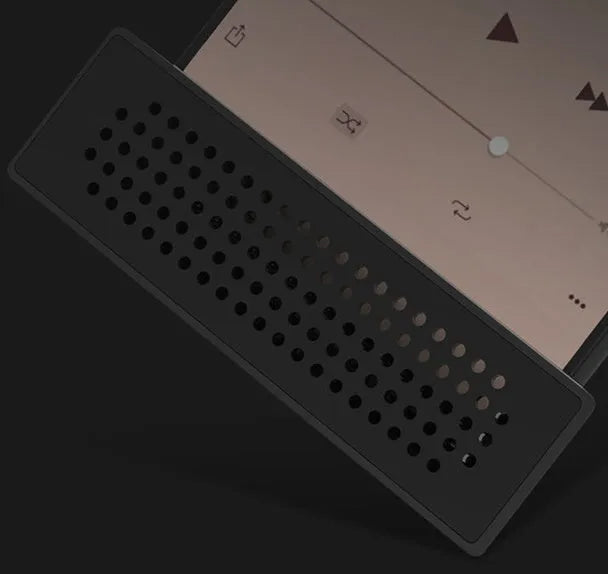 Compact black mobile phone amplifier bracket holding an iPhone on a desktop.