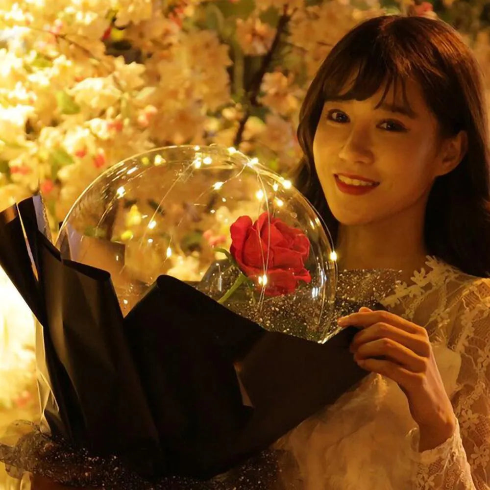 Transparent LED luminous balloon with artificial rose and built-in light, shown as a DIY bouquet kit.