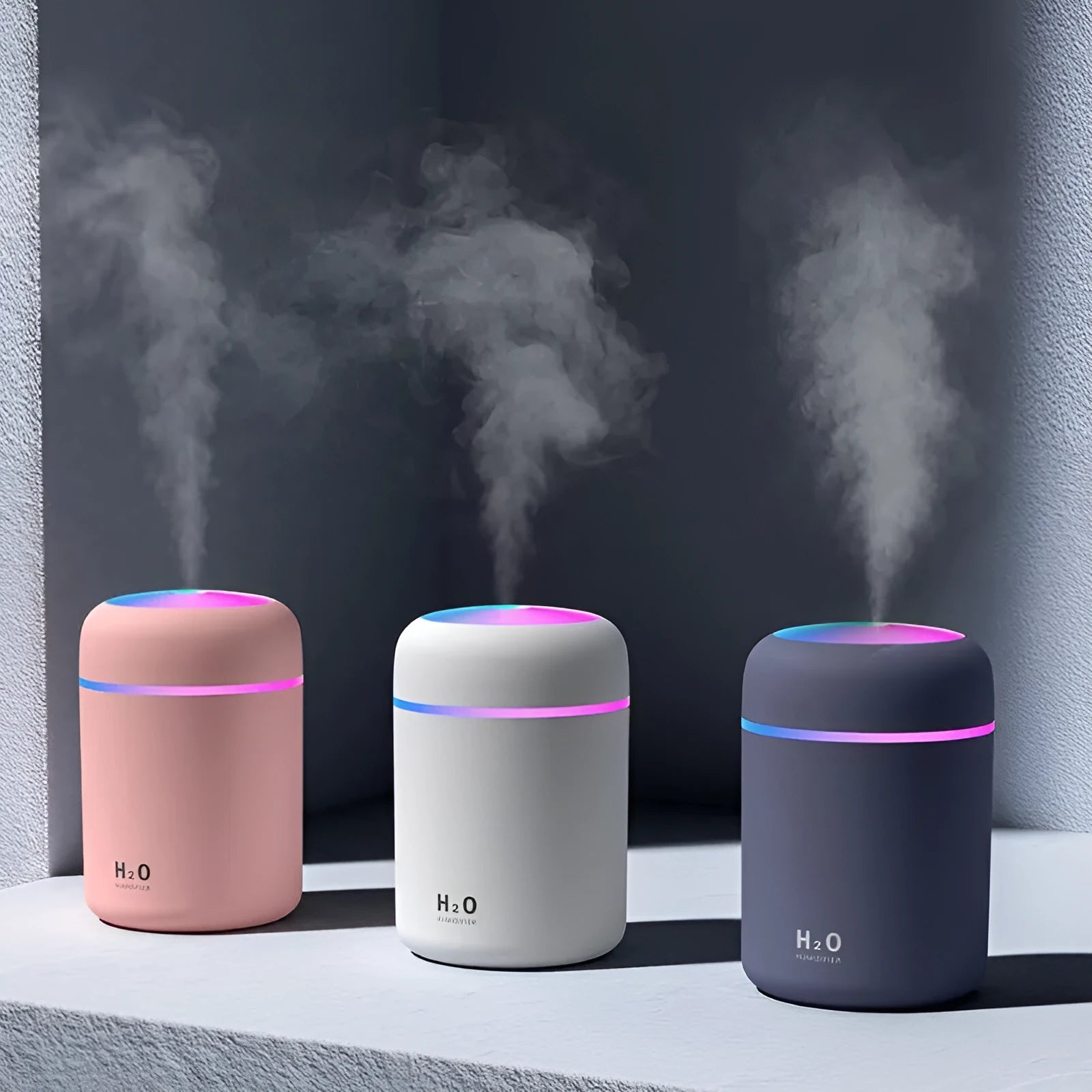 Pink USB portable humidifier with 300ml water tank on wooden desk surface