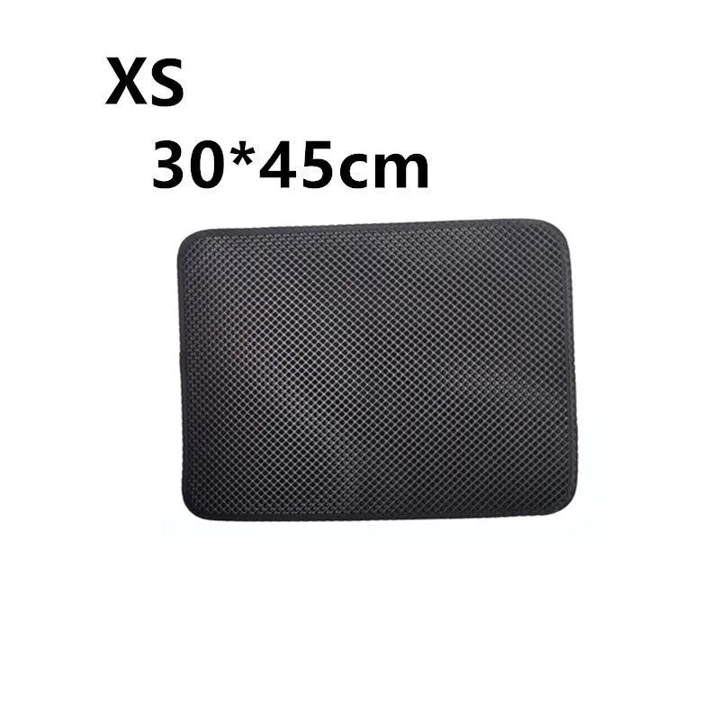 Double layer EVA cat litter mat in black with textured surface, placed under a litter box to trap debris
