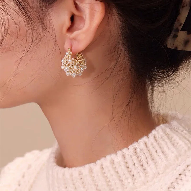 Women's gold-coloured copper flower basket earrings with small bead detailing and pearl inlay treatment
