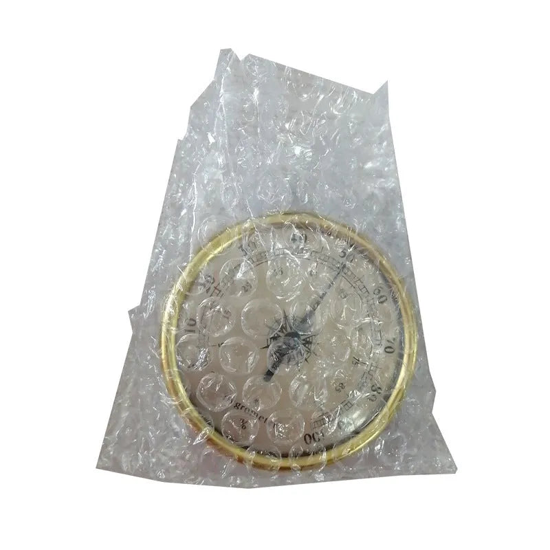 Analog thermometer and hygrometer with aluminium ring and dial showing temperature and humidity scales.