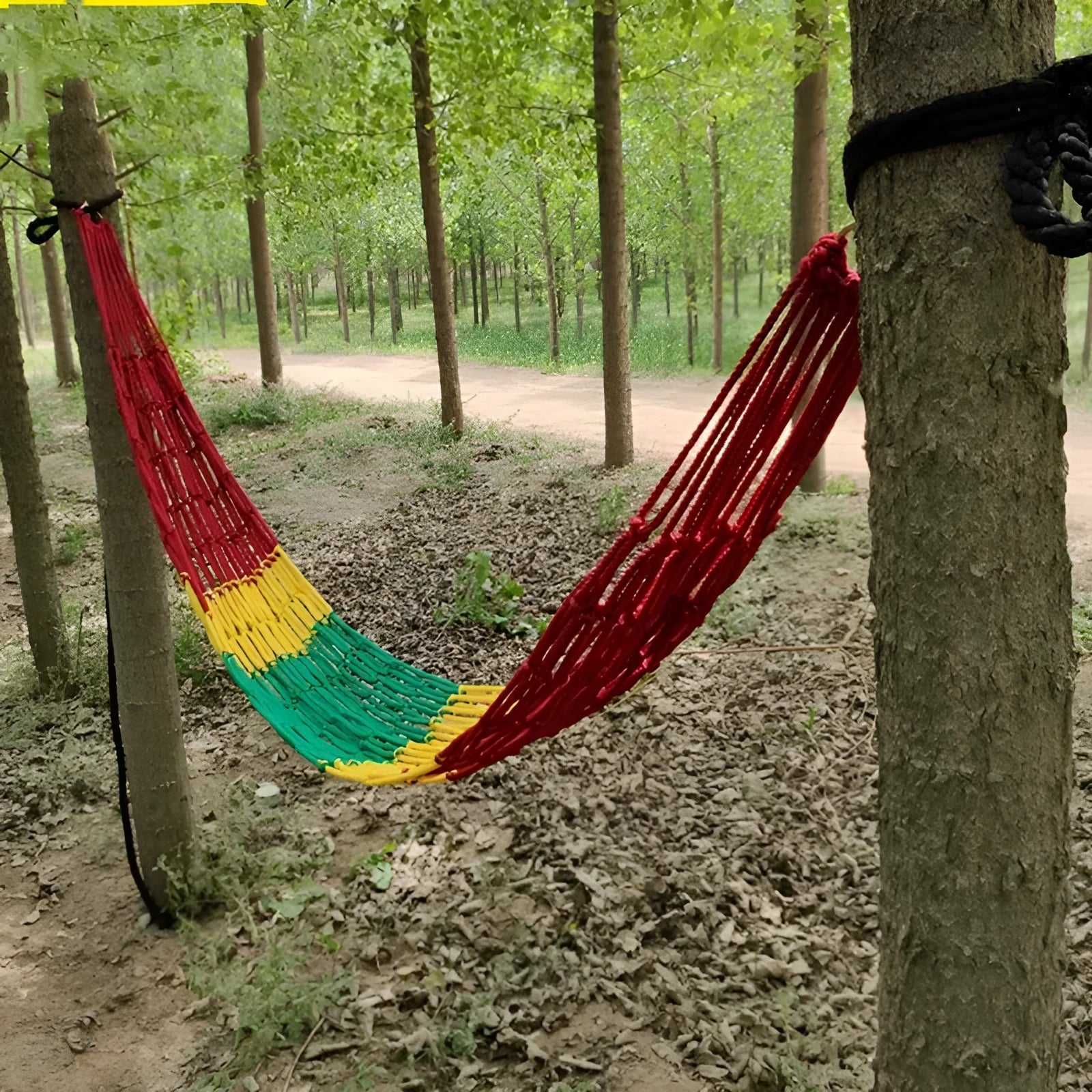 Nylon rope mesh hammock hung between trees showing 1.1m width
