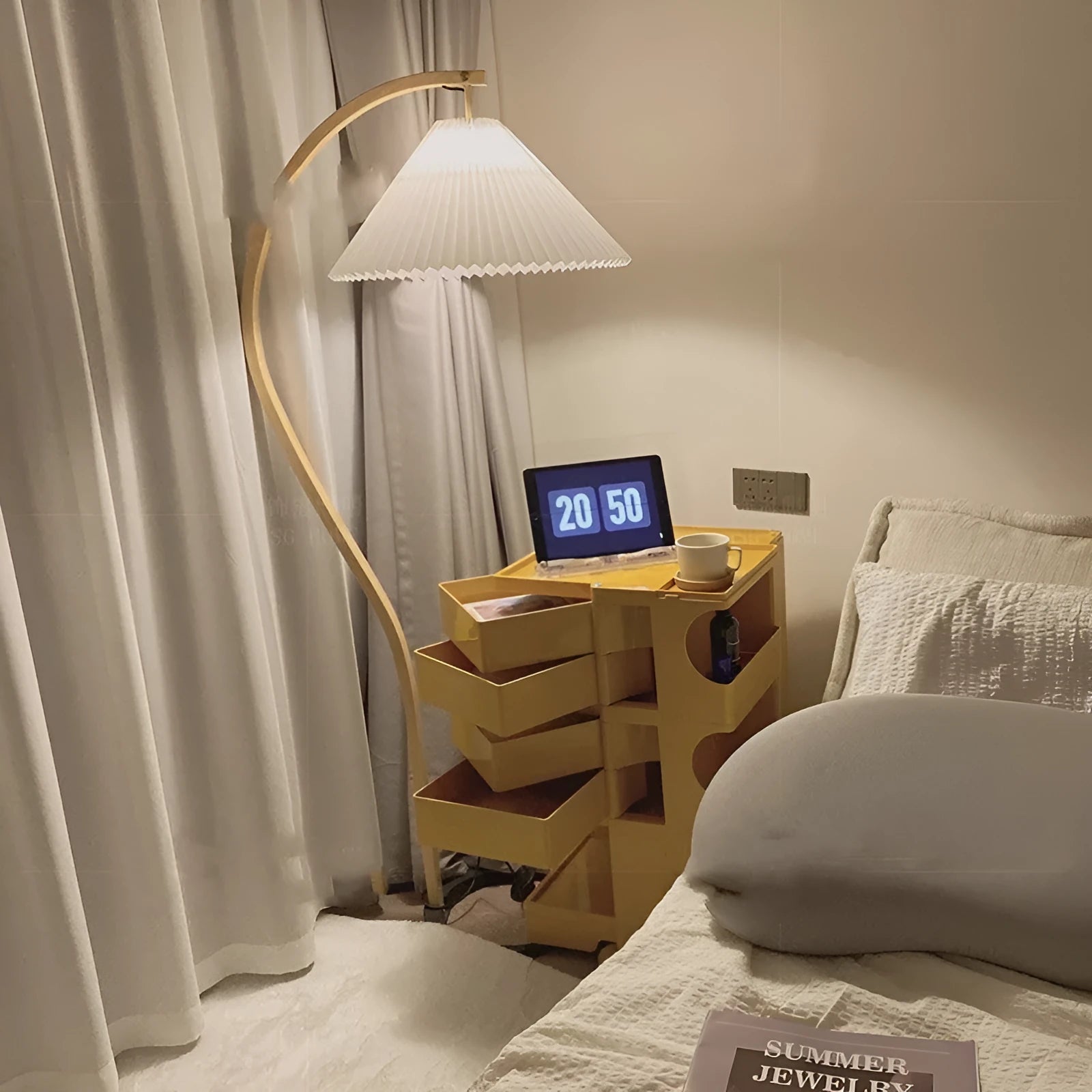 Retro vertical table lamp with tall stand and choice of log white or wine red shade on a bedside table.