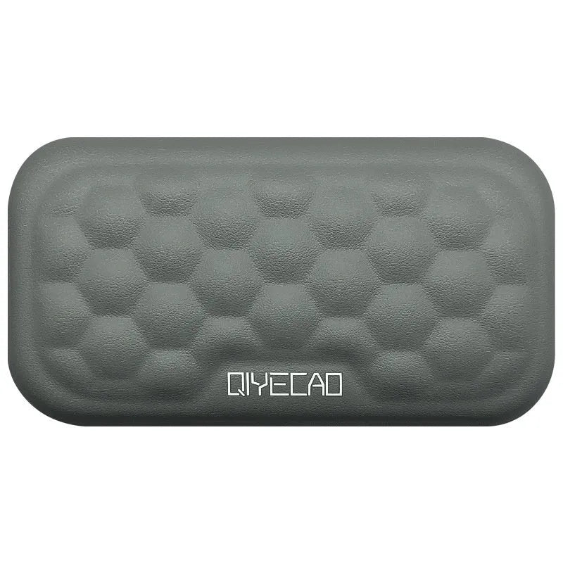 Customisable memory foam mouse wrist pad with black cloth cover on a desk.
