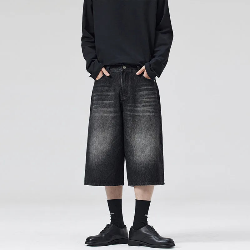 Men's light blue loose-fit cropped denim shorts with a straight leg on a neutral background.