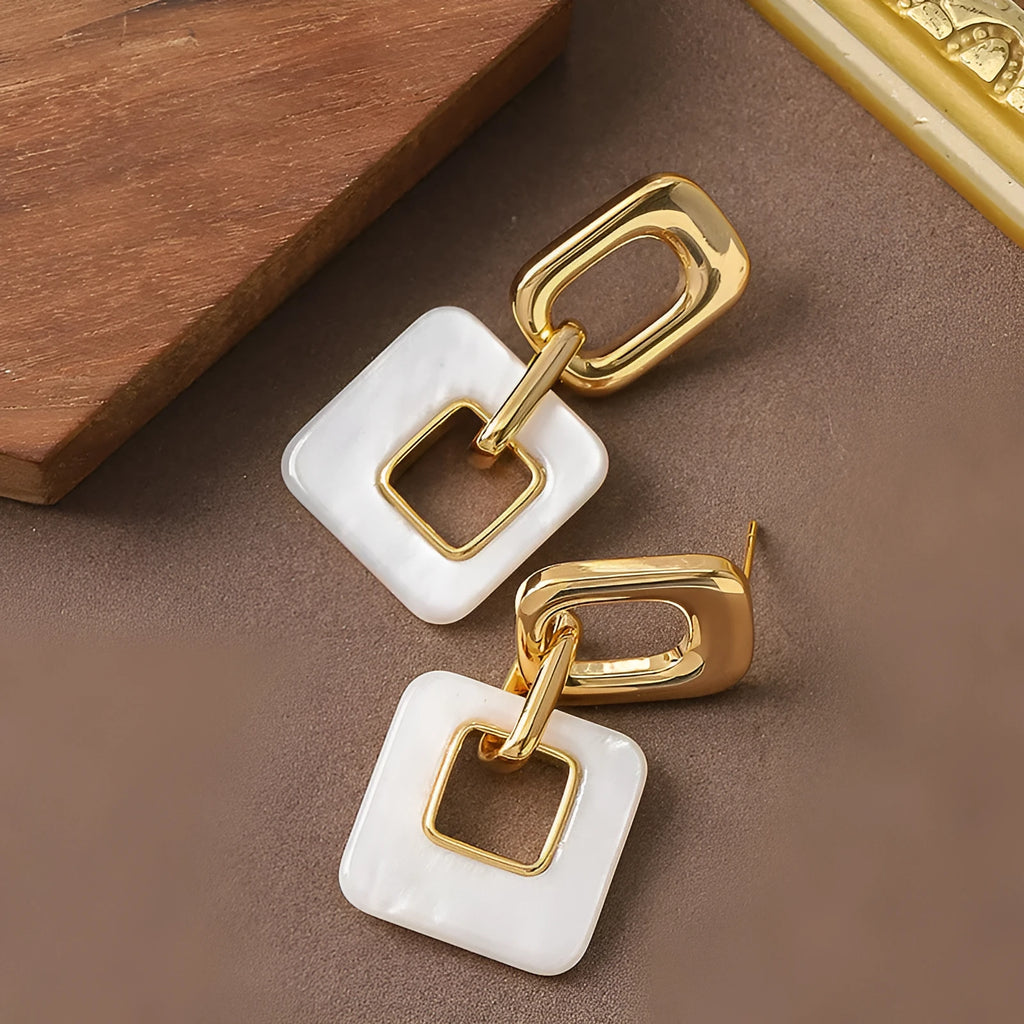 Hollow geometric square earrings with chamfered corners in metallic finish